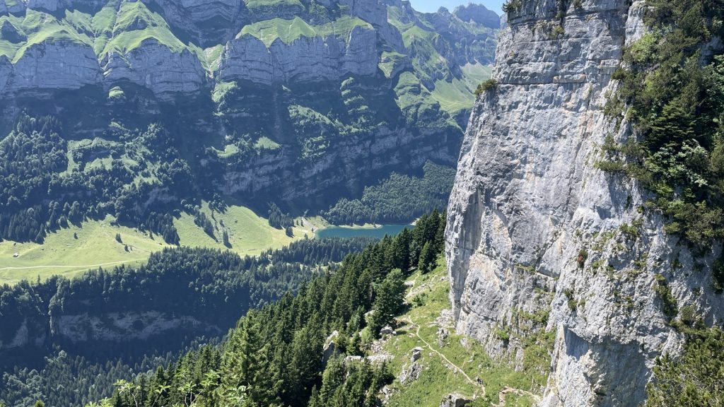 Wanderweg - rechts Felsen - links unten ein türkisfarbener See